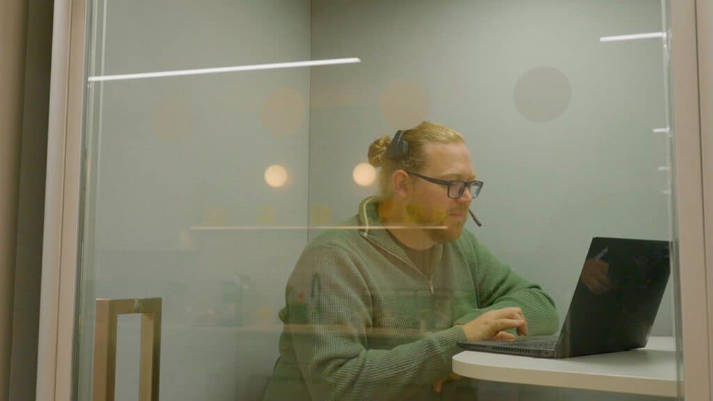 Employee talking whilst on laptop