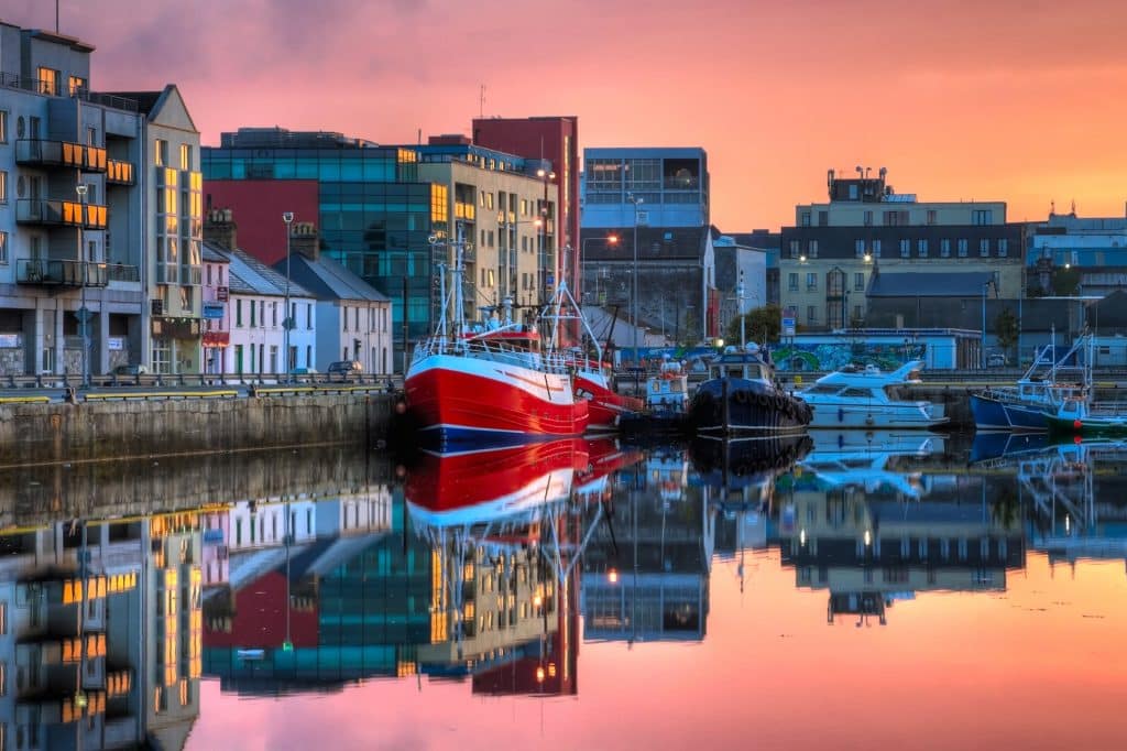 Morning view on row of buildings and fishing boats in Galway