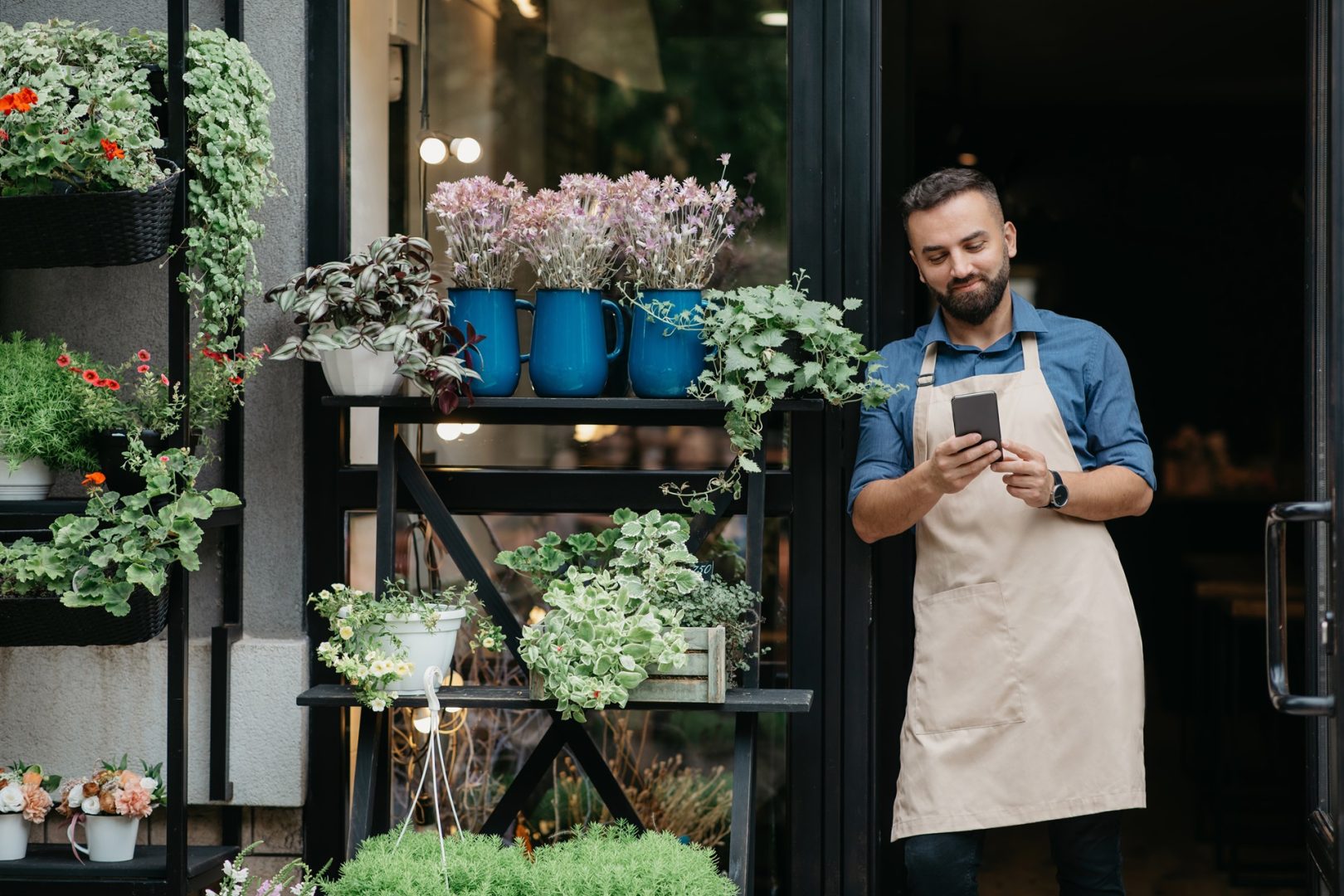 Small business owner florist standing in the porch of shop